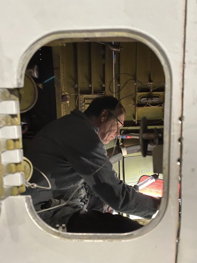 Man working inside of an airplane.