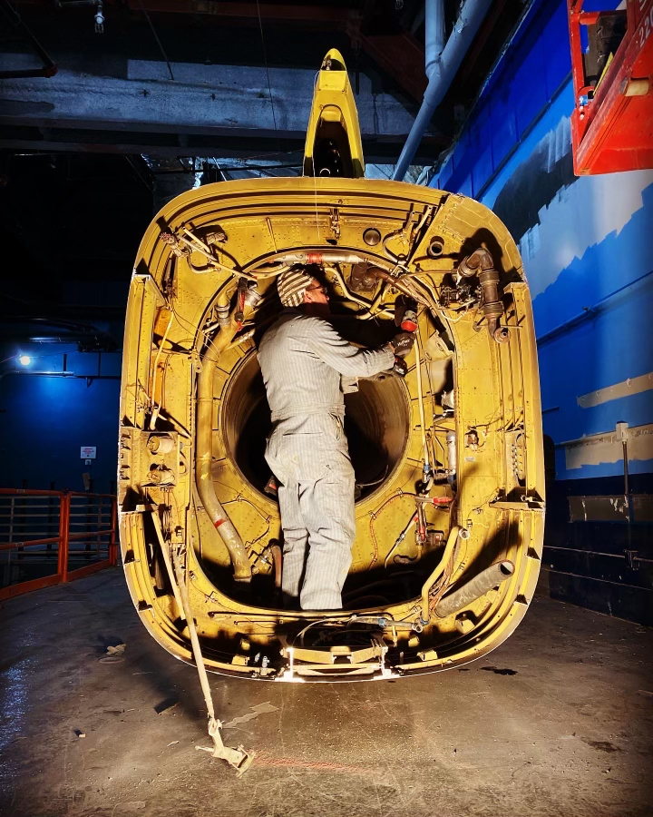 Man inside of an airplane working.